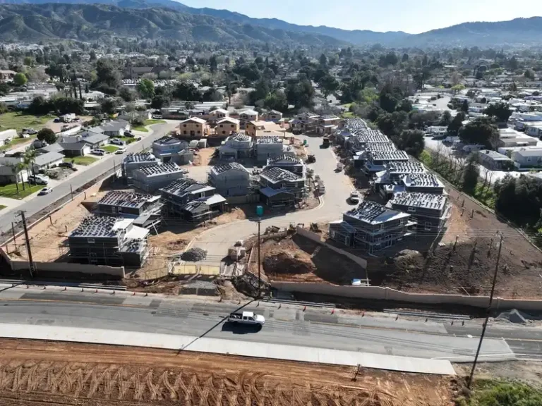 Aerial view of a housing development under construction in a suburban neighborhood.