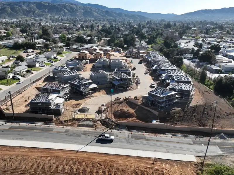 Aerial view of a housing development under construction in a suburban neighborhood.