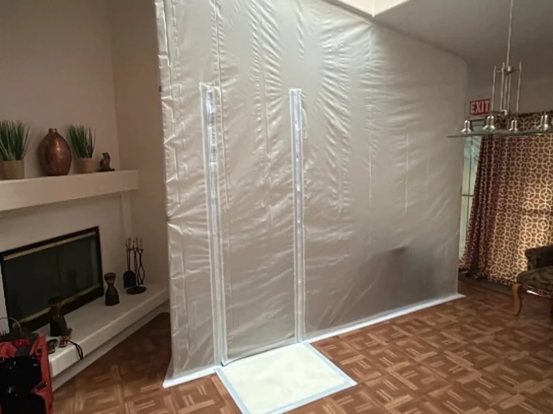 Large white plastic containment tent in a living room.