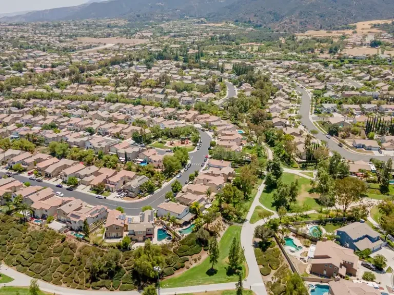 Aerial view of a suburban neighborhood with winding streets and houses.